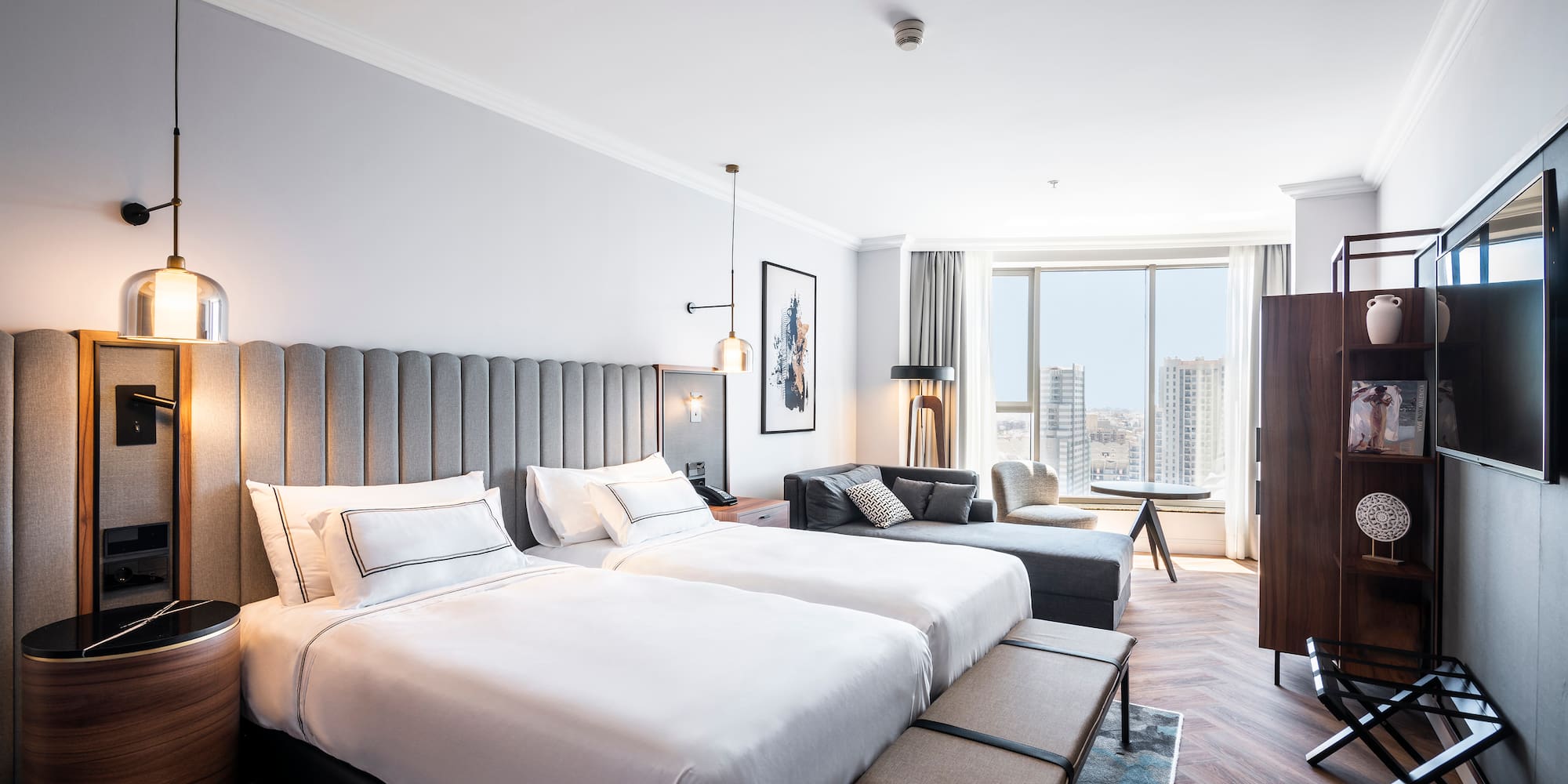 a room with two beds and a couch