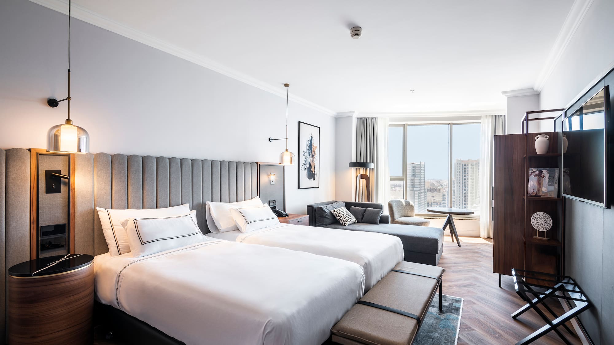 a room with two beds and a couch