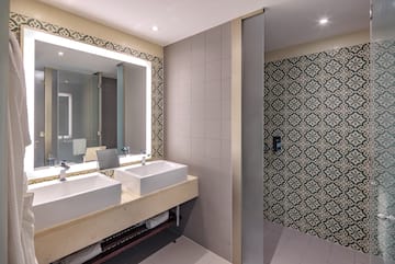 a bathroom with sinks and a mirror