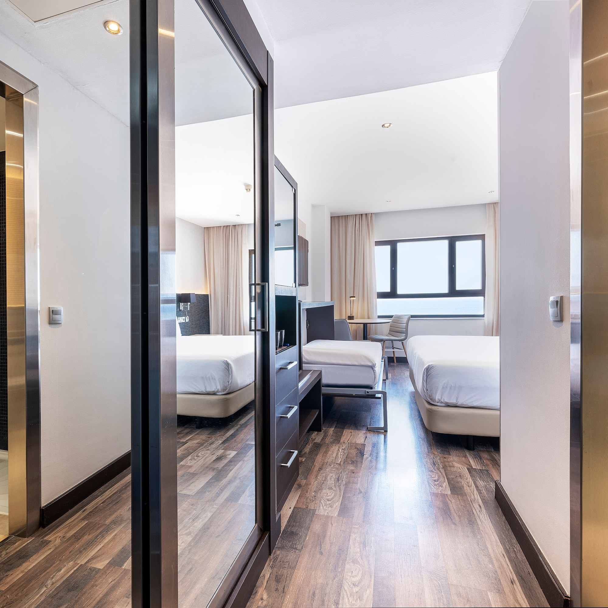 a room with a mirror door and a bed