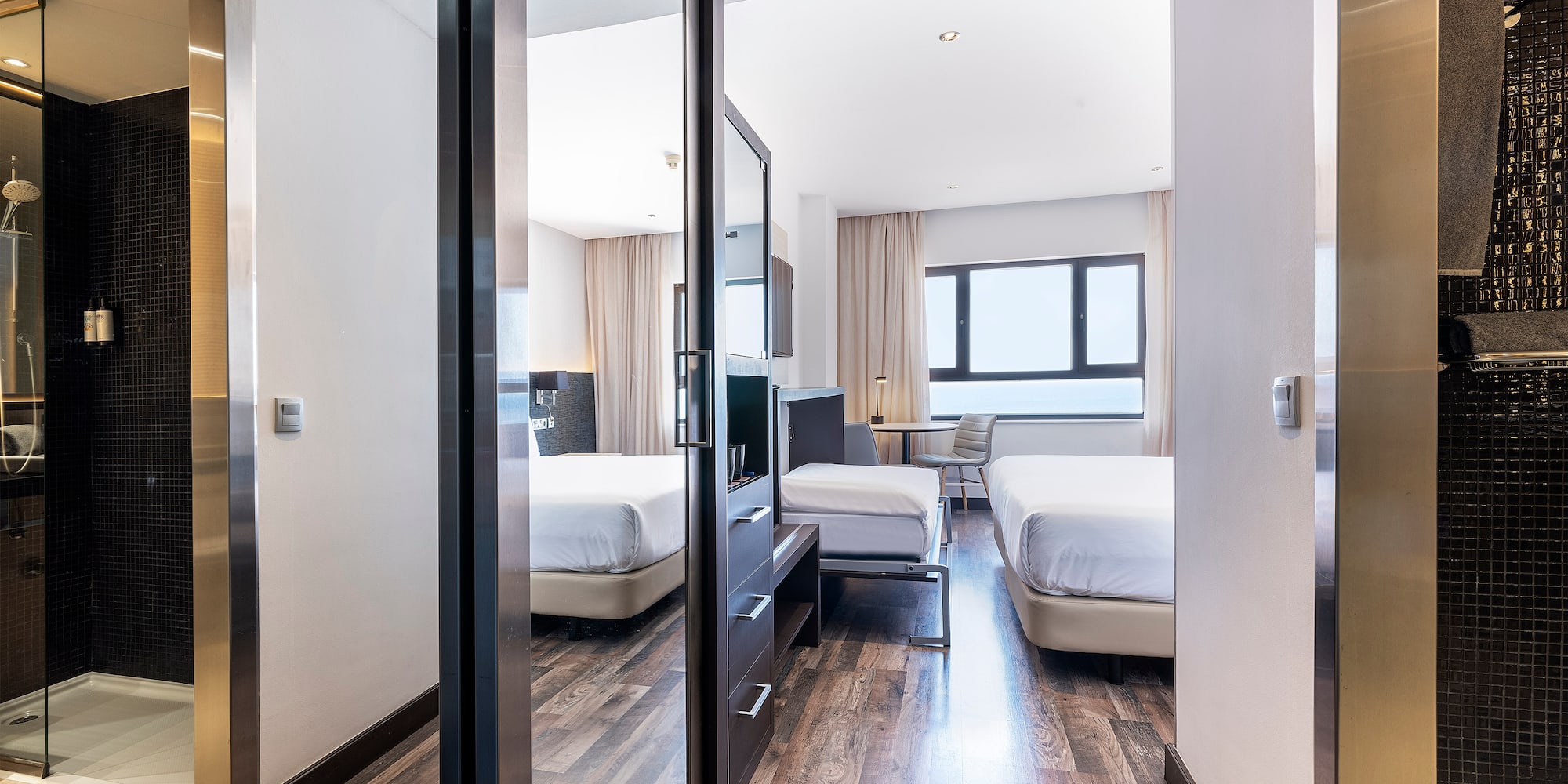 a room with a mirror door and a bed