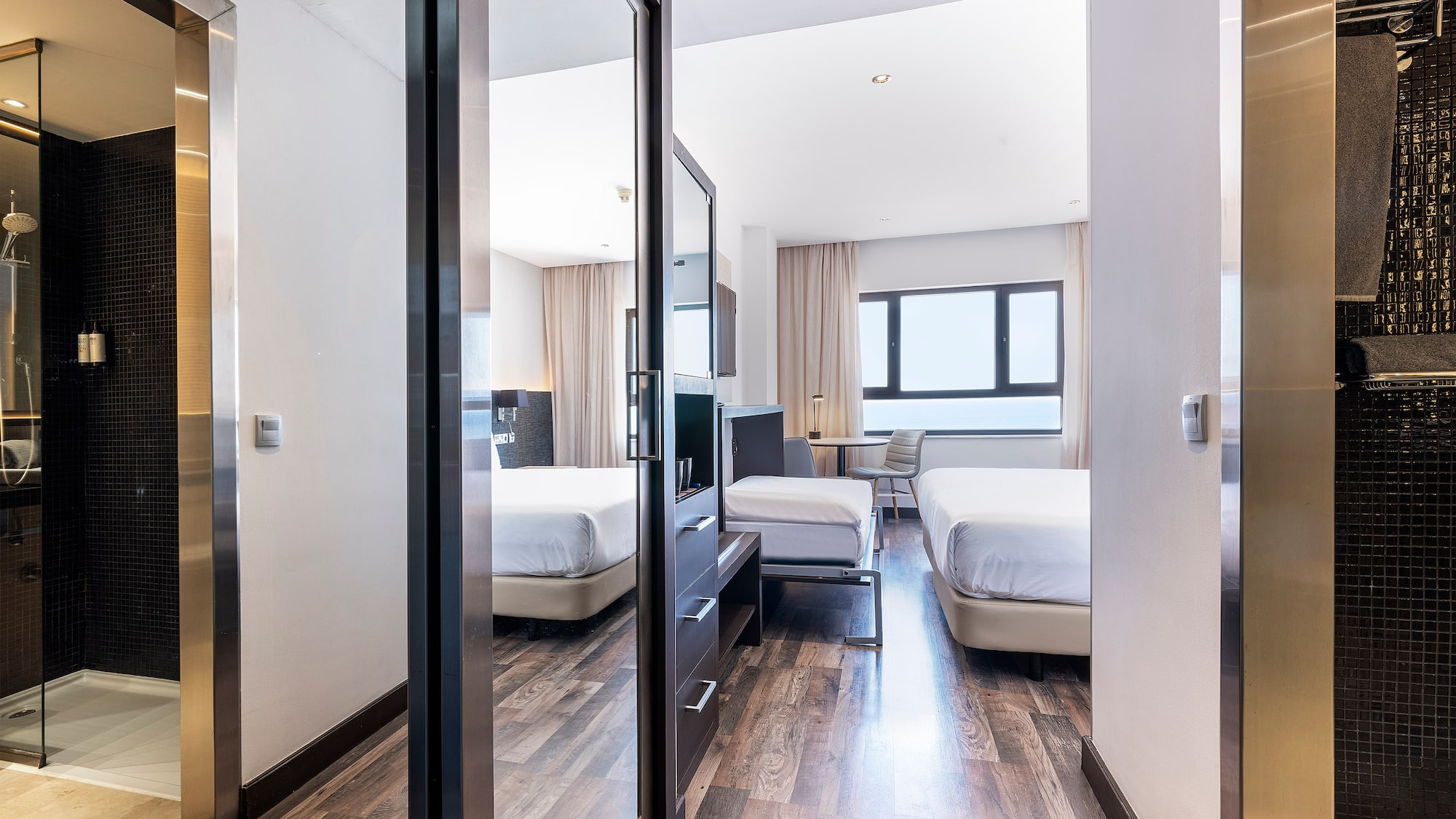 a room with a mirror door and a bed