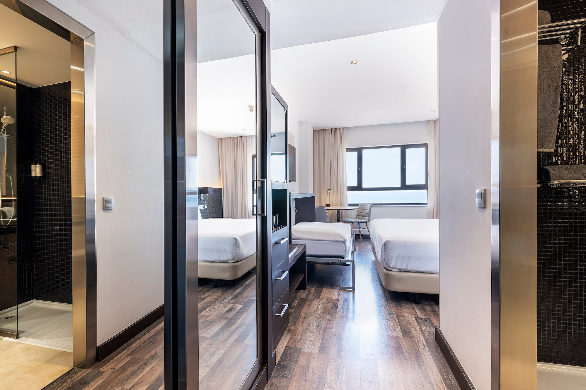 a room with a mirror door and a bed