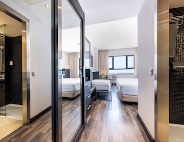 a room with a mirror door and a bed