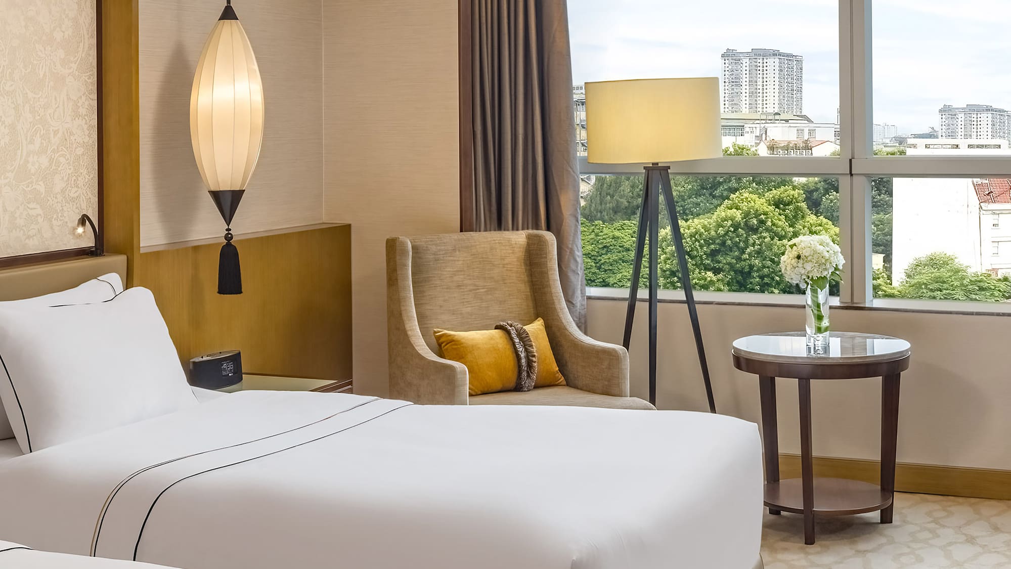 a room with two beds and a lamp