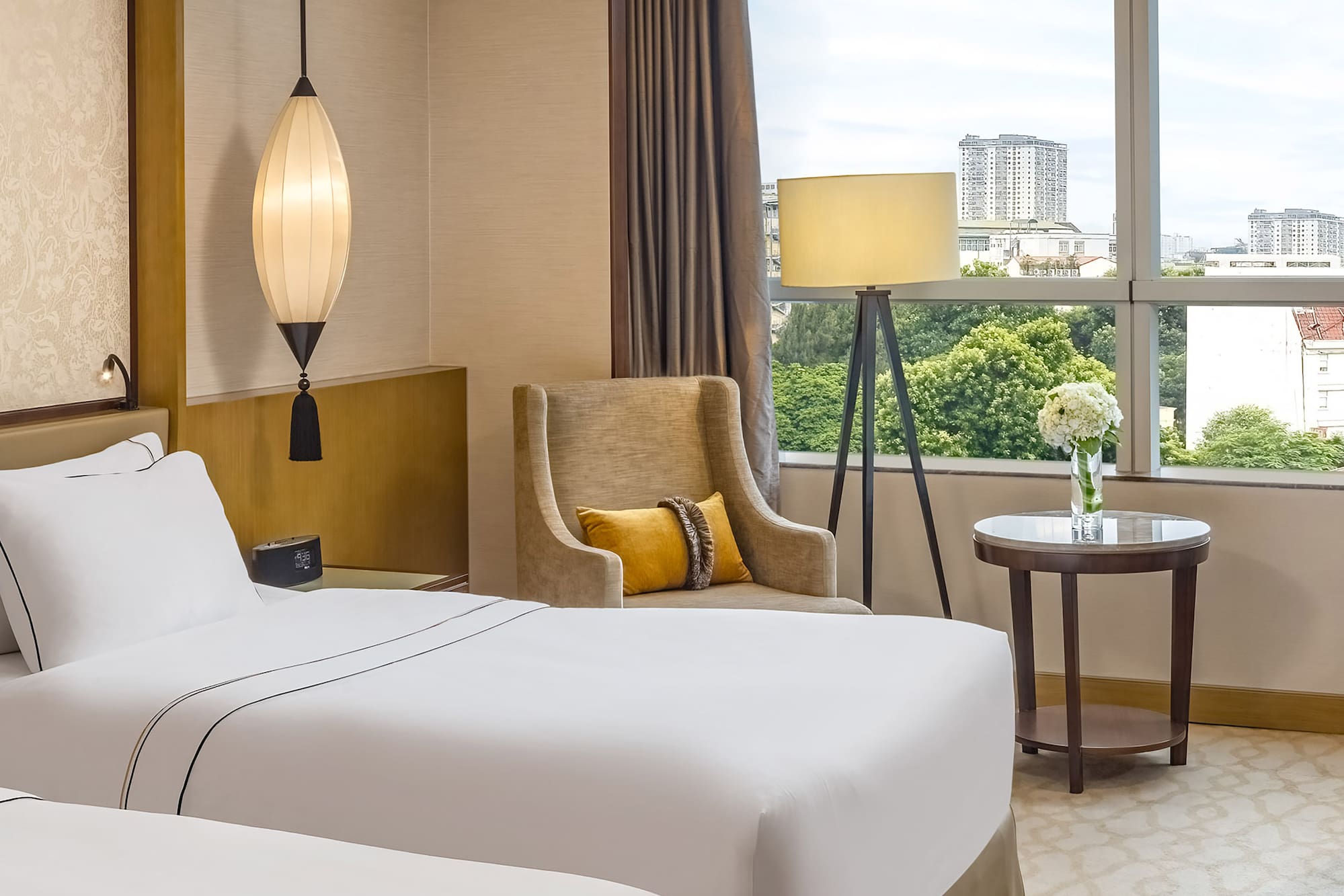 a room with two beds and a lamp