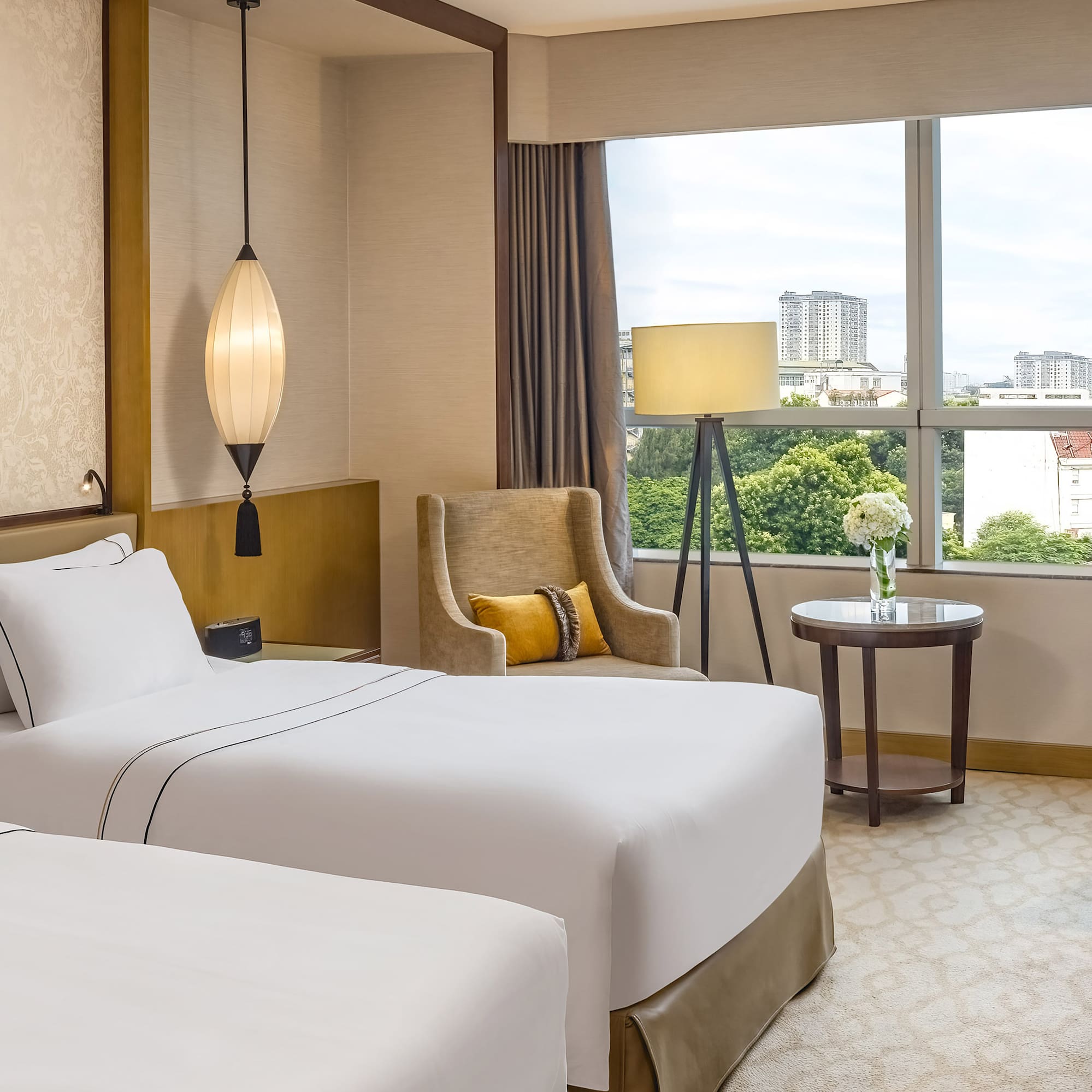 a room with two beds and a lamp