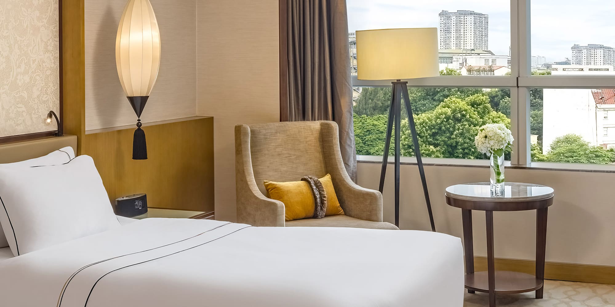 a room with two beds and a lamp