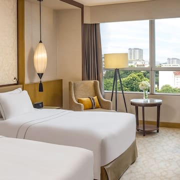 a room with two beds and a lamp