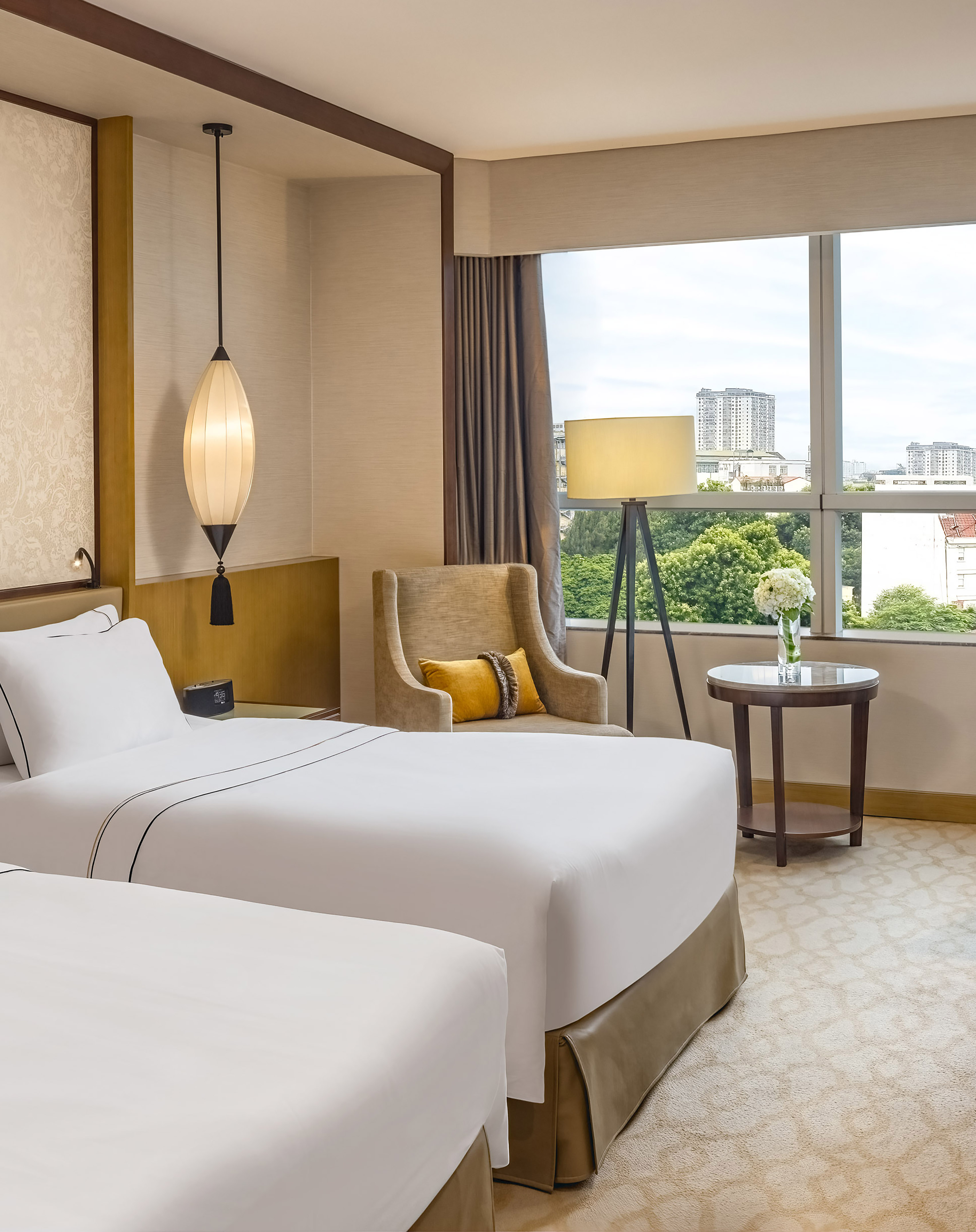 a room with two beds and a lamp