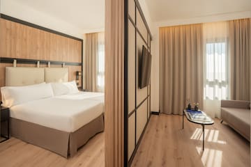 a room with a bed and a tv