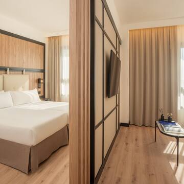 a room with a bed and a tv