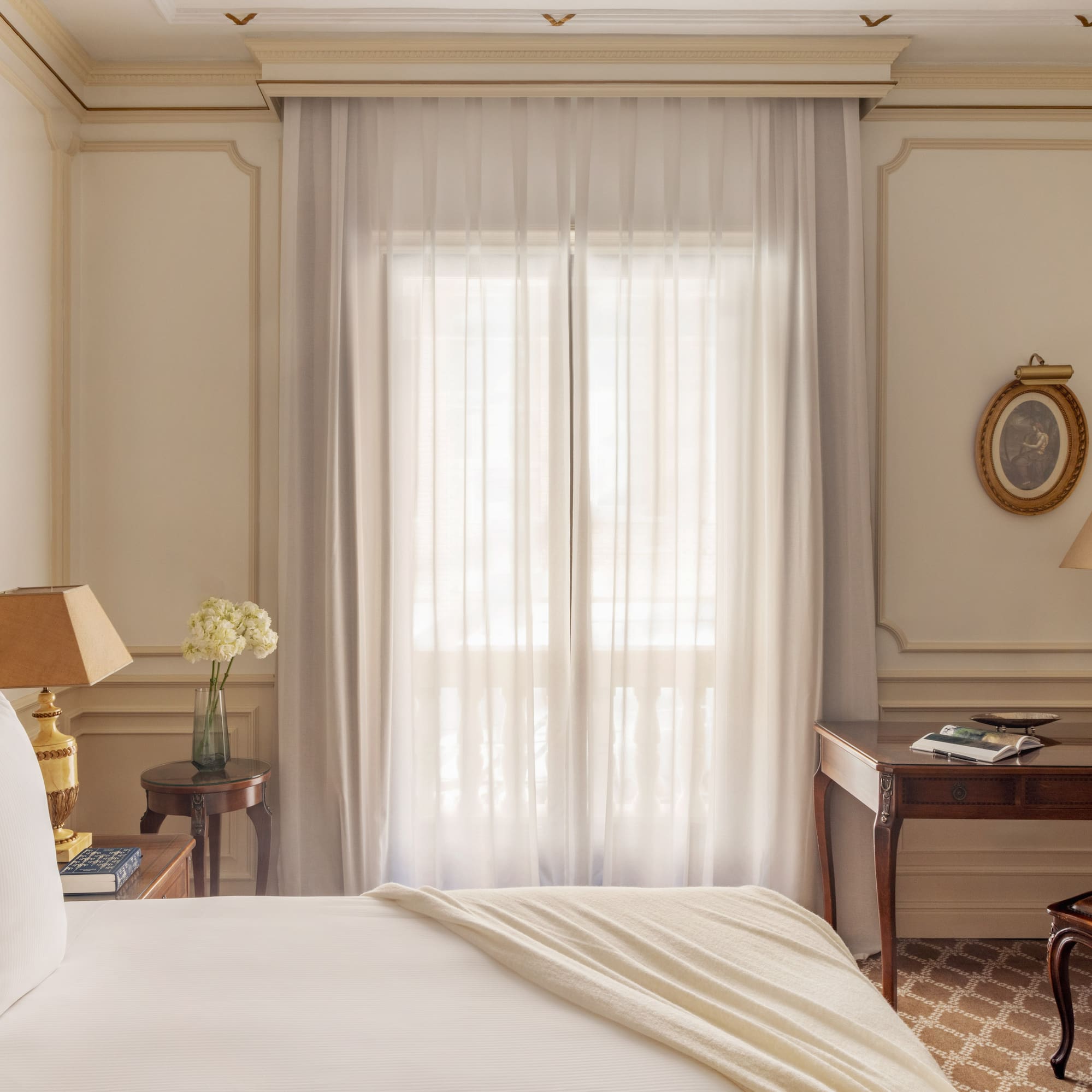 a bedroom with a bed and a table and lamp