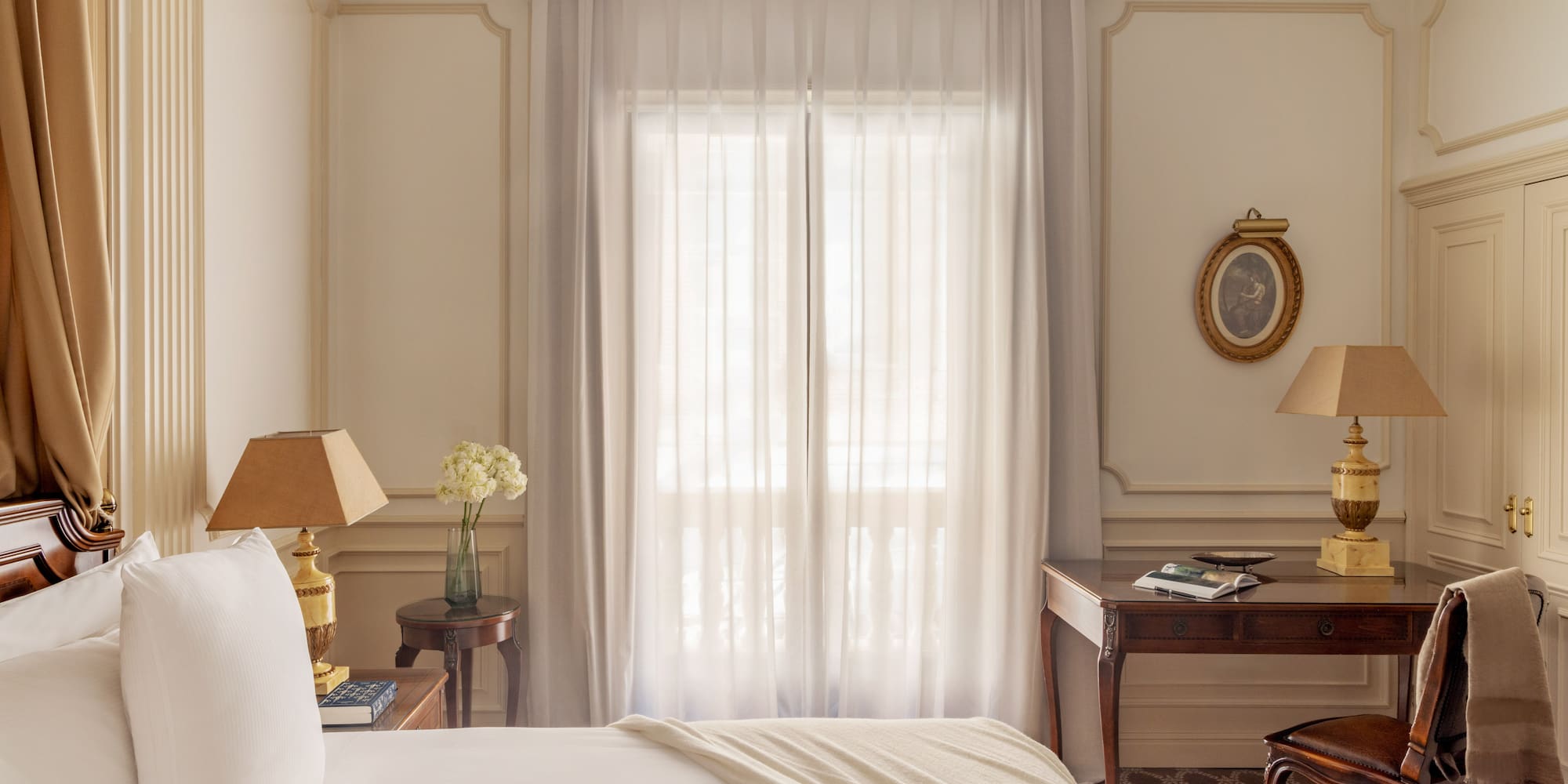 a bedroom with a bed and a table and lamp