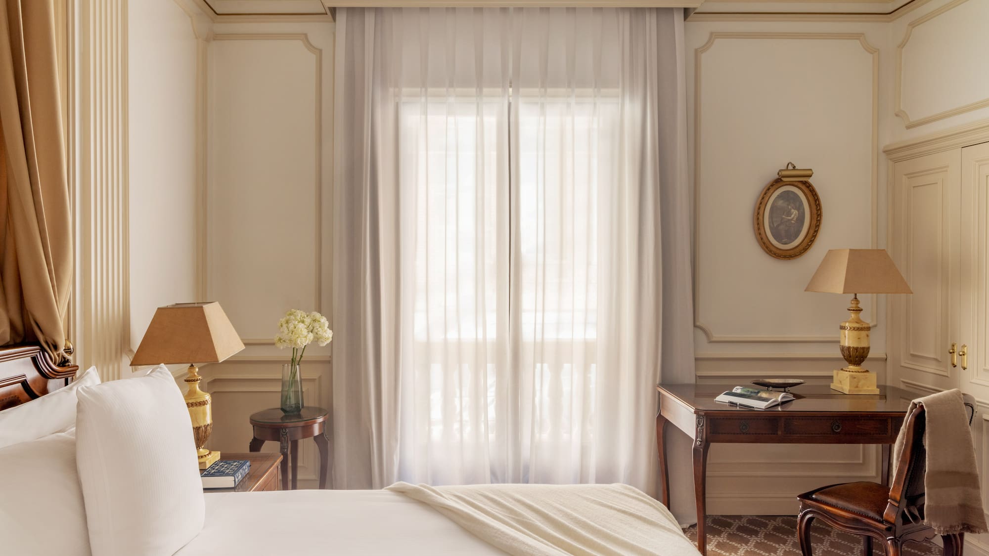 a bedroom with a bed and a table and lamp