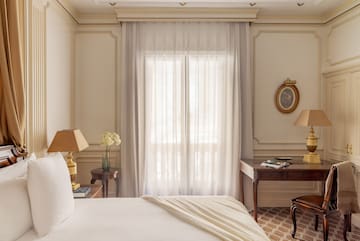 a bedroom with a bed and a table and lamp