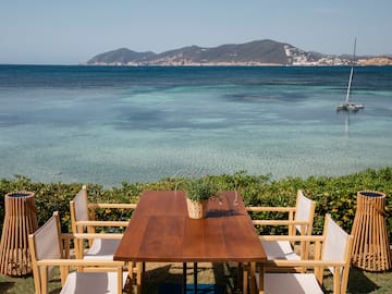 a table and chairs overlooking a body of water