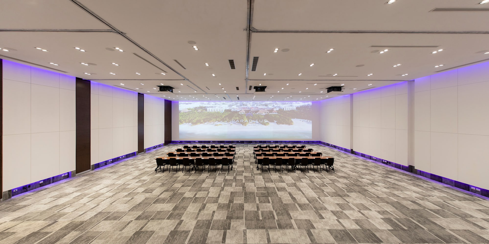 a room with chairs and a projector screen