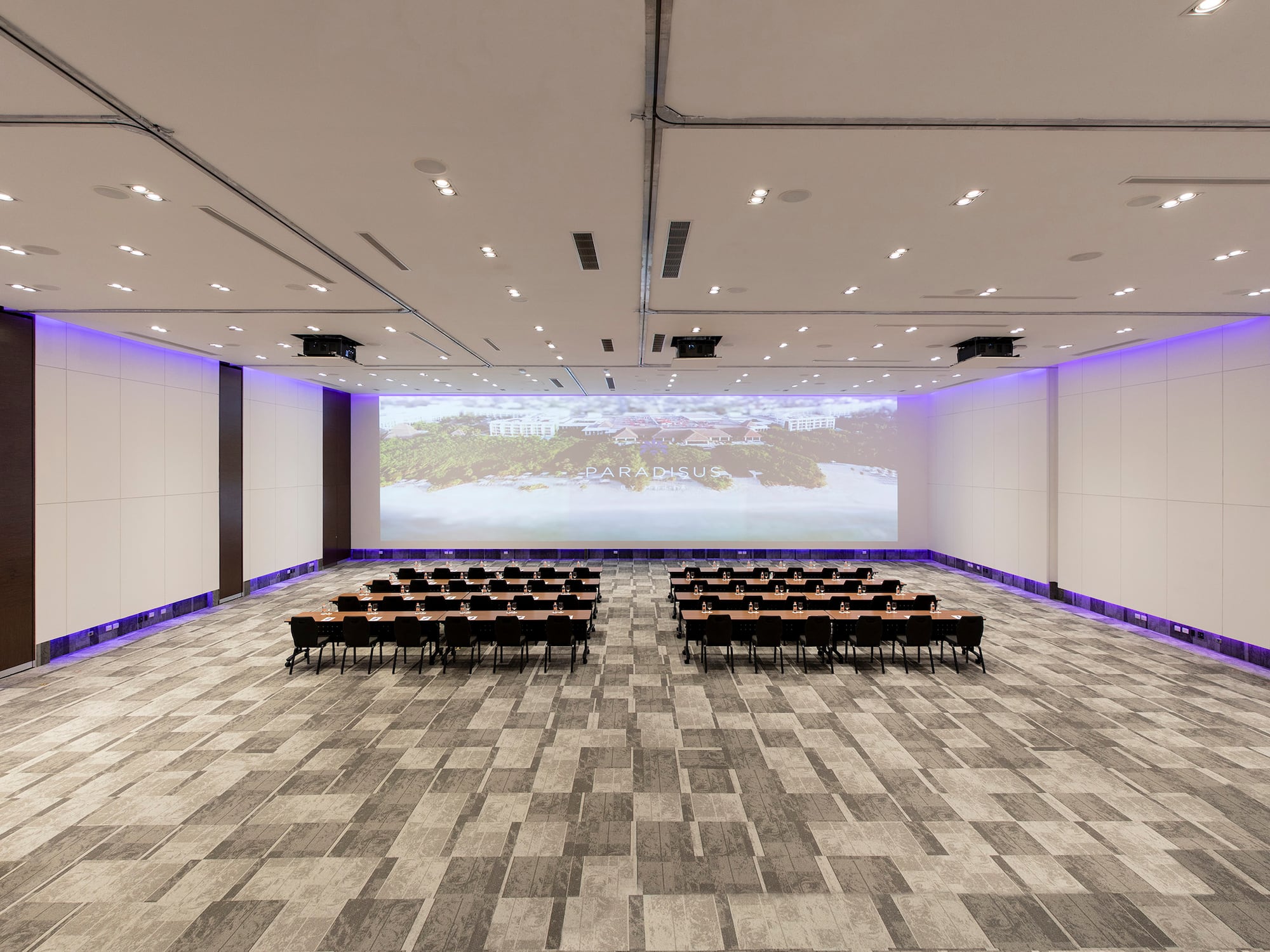 a room with chairs and a projector screen