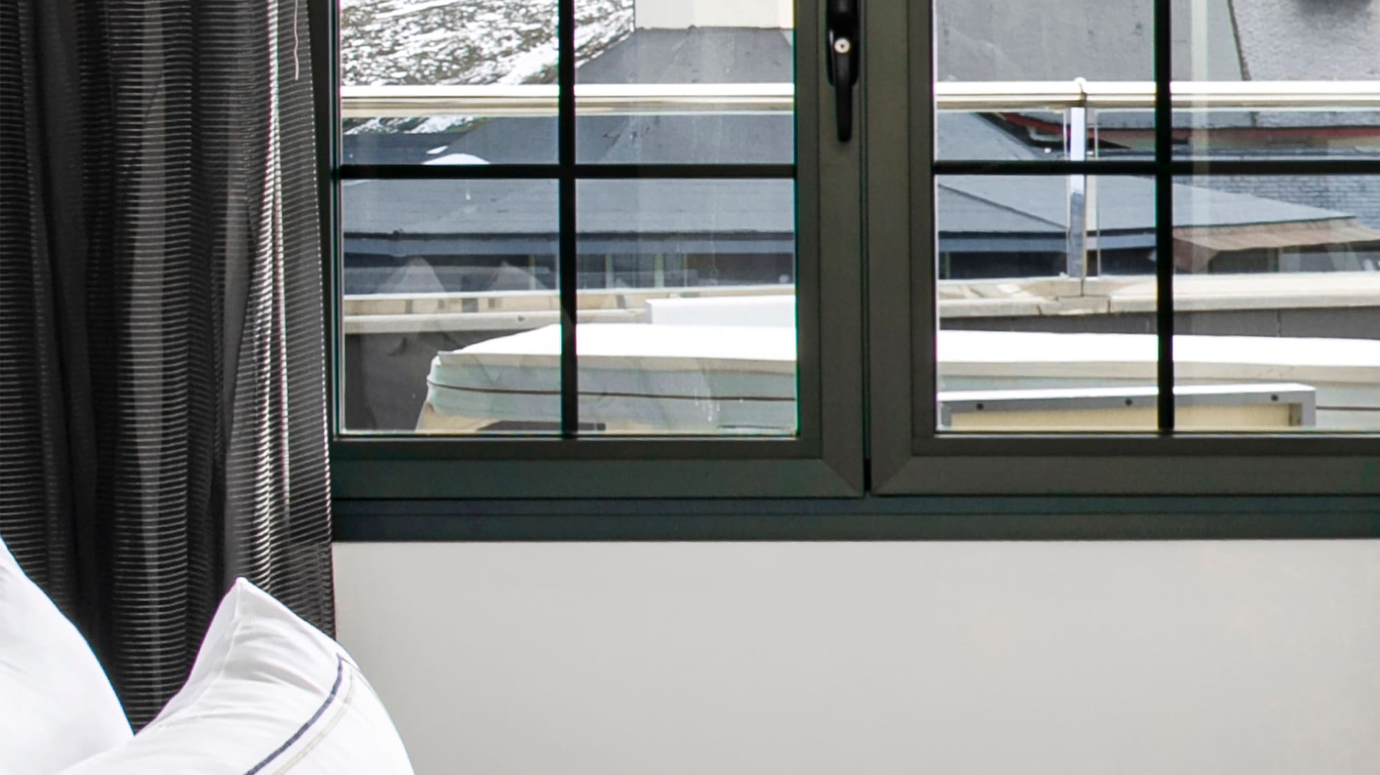 a bed with a window and a view of the mountains