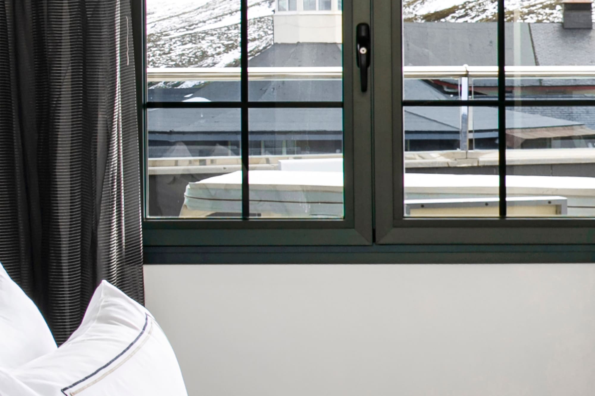 a bed with a window and a view of the mountains