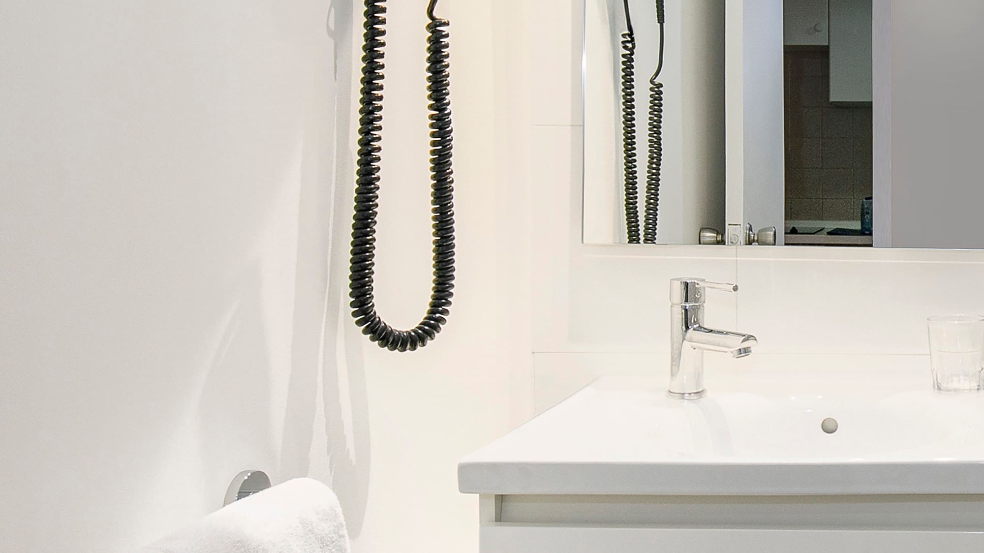 a bathroom with a sink and hair dryer