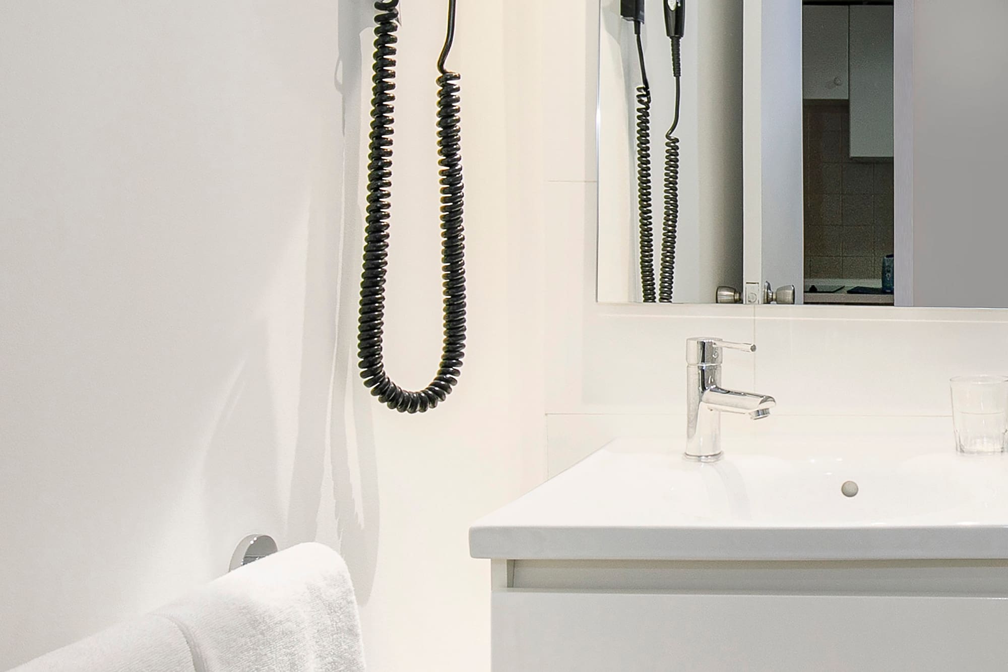 a bathroom with a sink and hair dryer