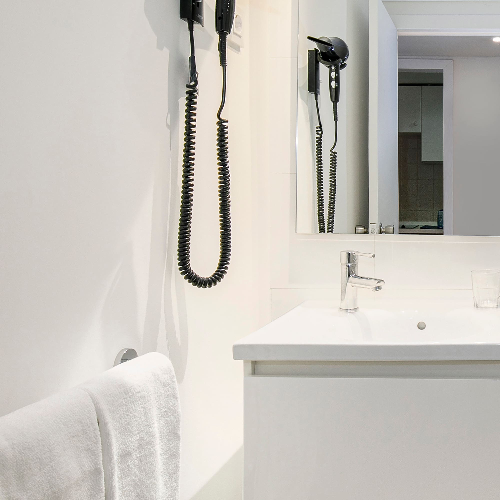 a bathroom with a sink and hair dryer