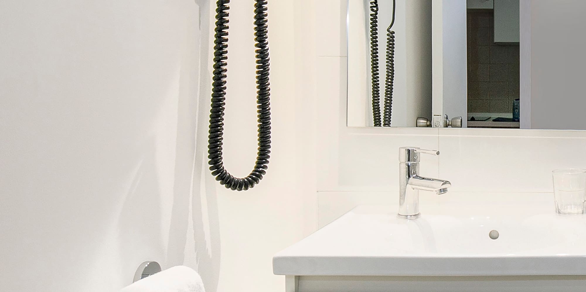 a bathroom with a sink and hair dryer