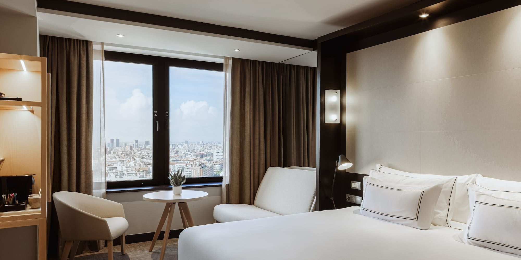 a room with a bed and chairs and a table