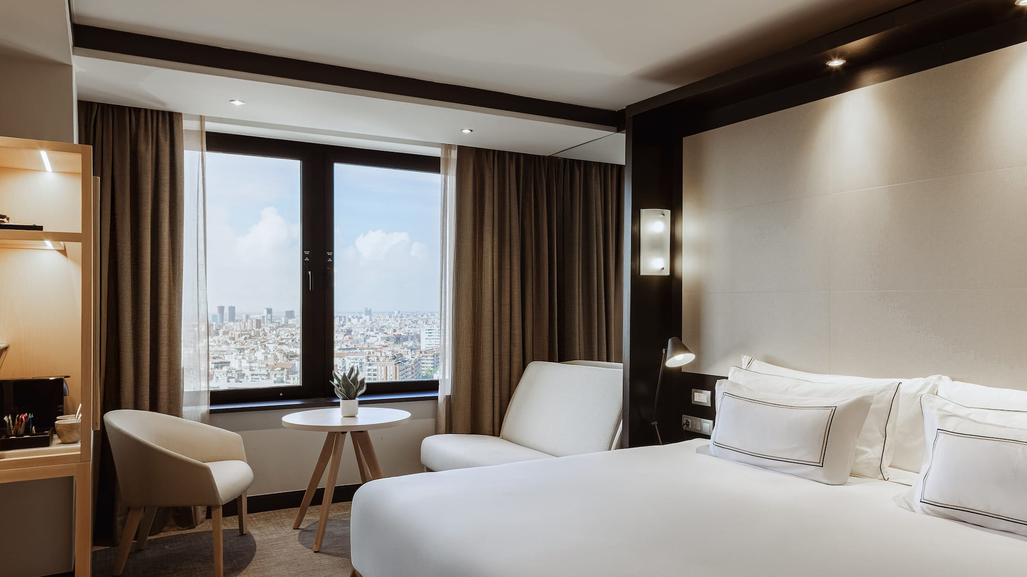 a room with a bed and chairs and a table