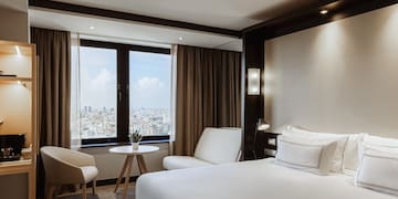 a room with a bed and chairs and a table