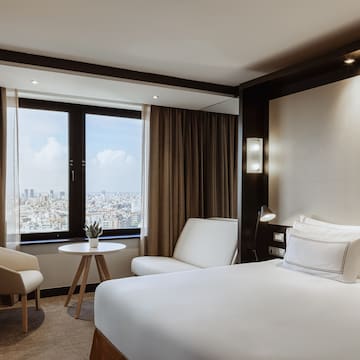 a room with a bed and chairs and a table