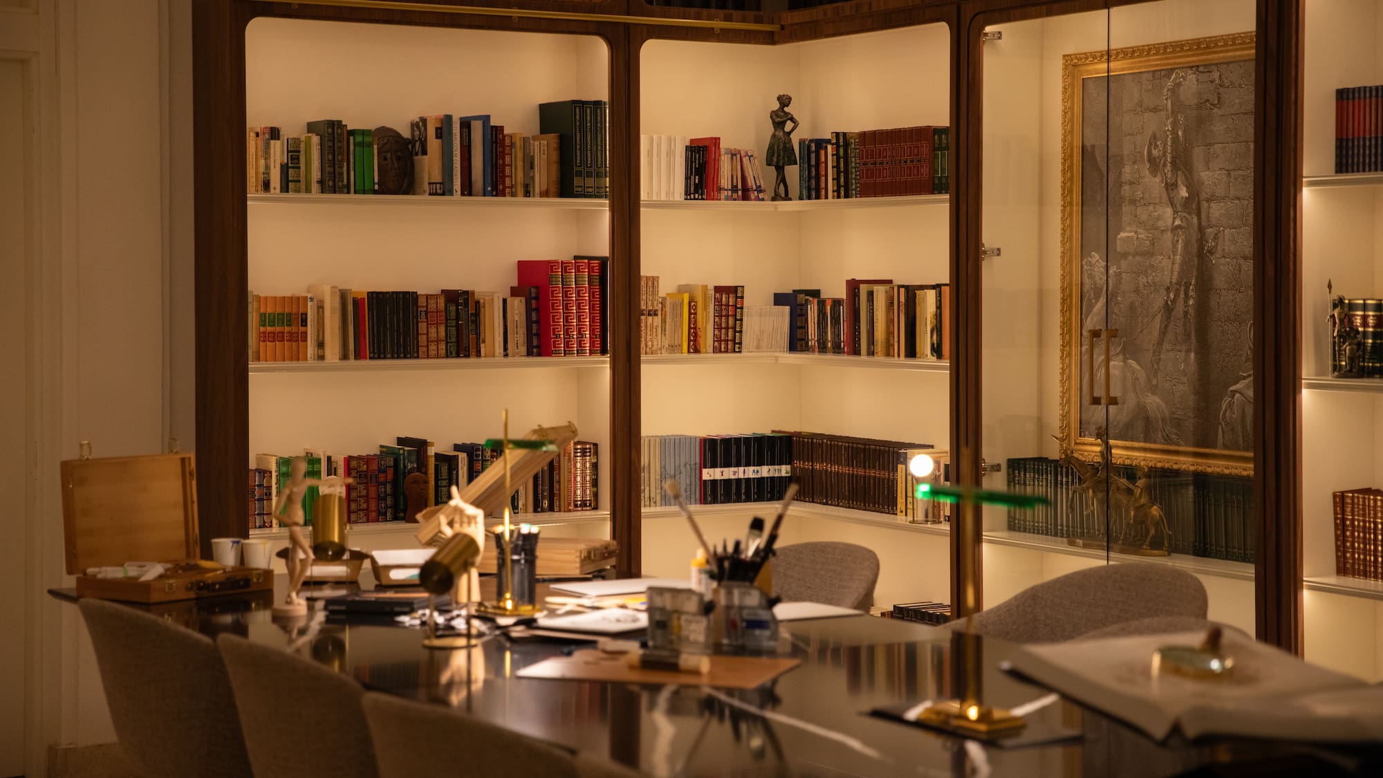 a room with a table and bookshelves