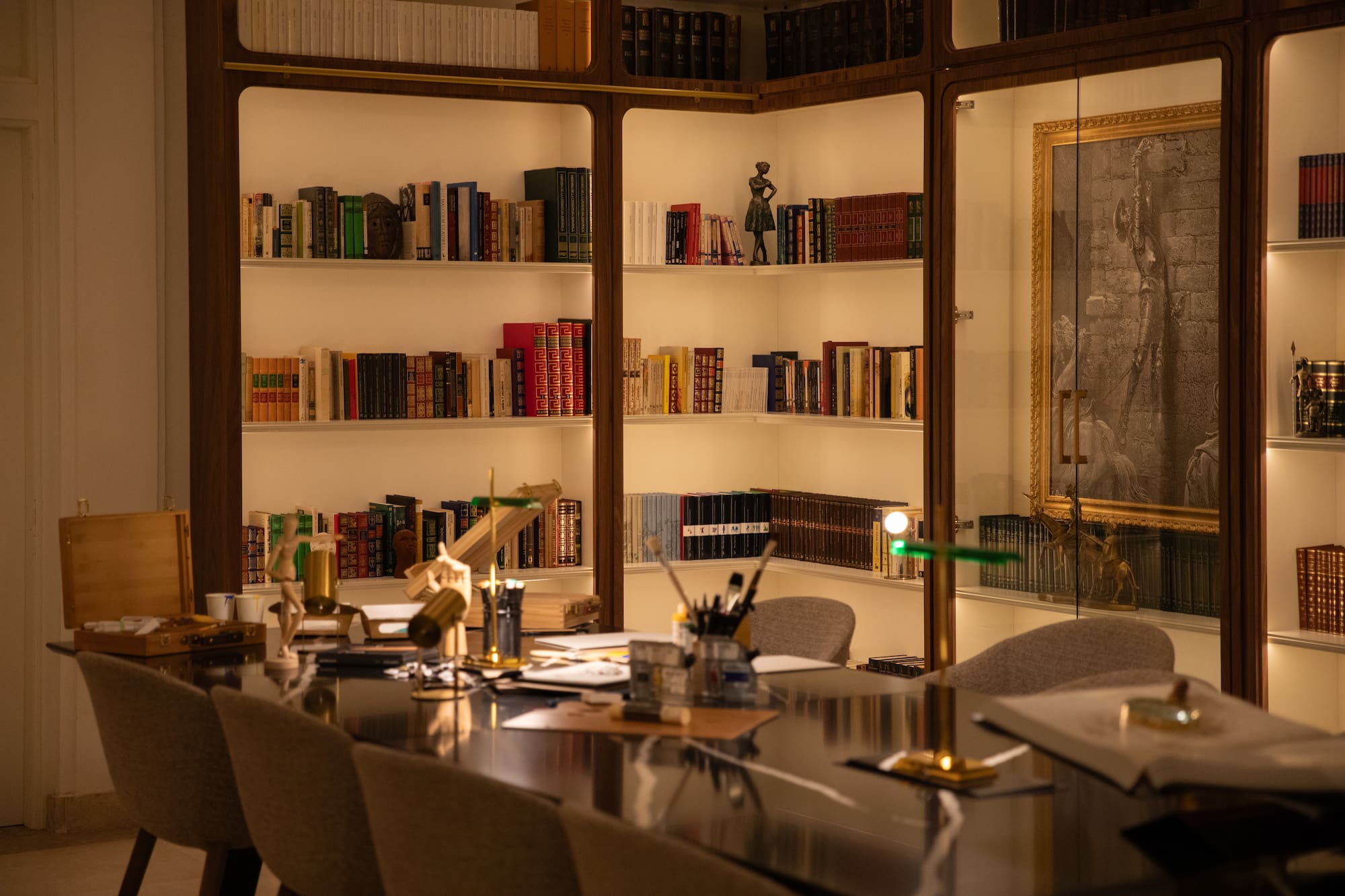 a room with a table and bookshelves