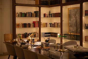 a room with a table and bookshelves