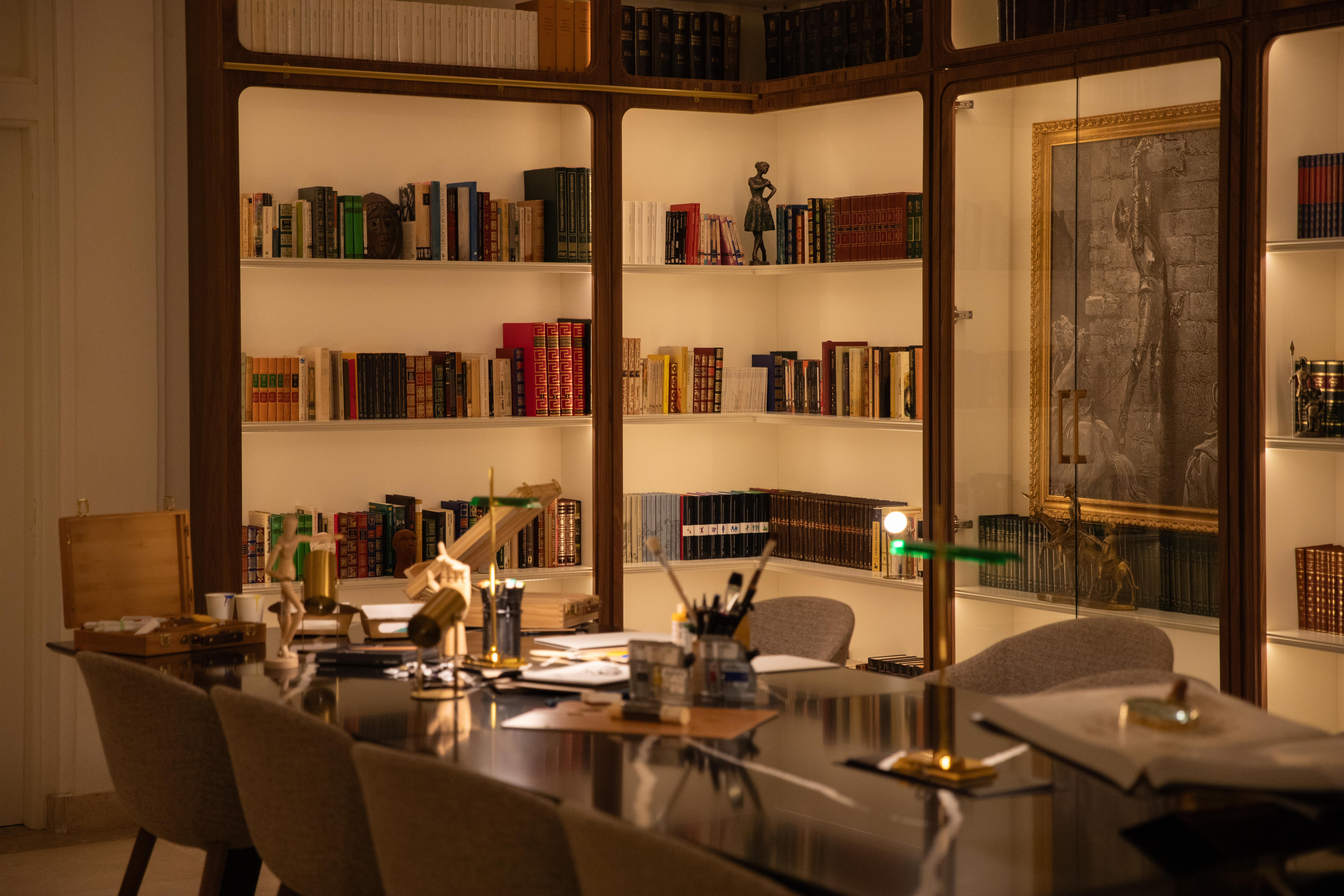 a room with a table and bookshelves