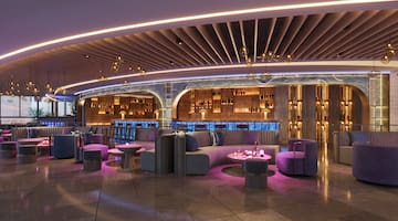 a room with purple furniture and a bar