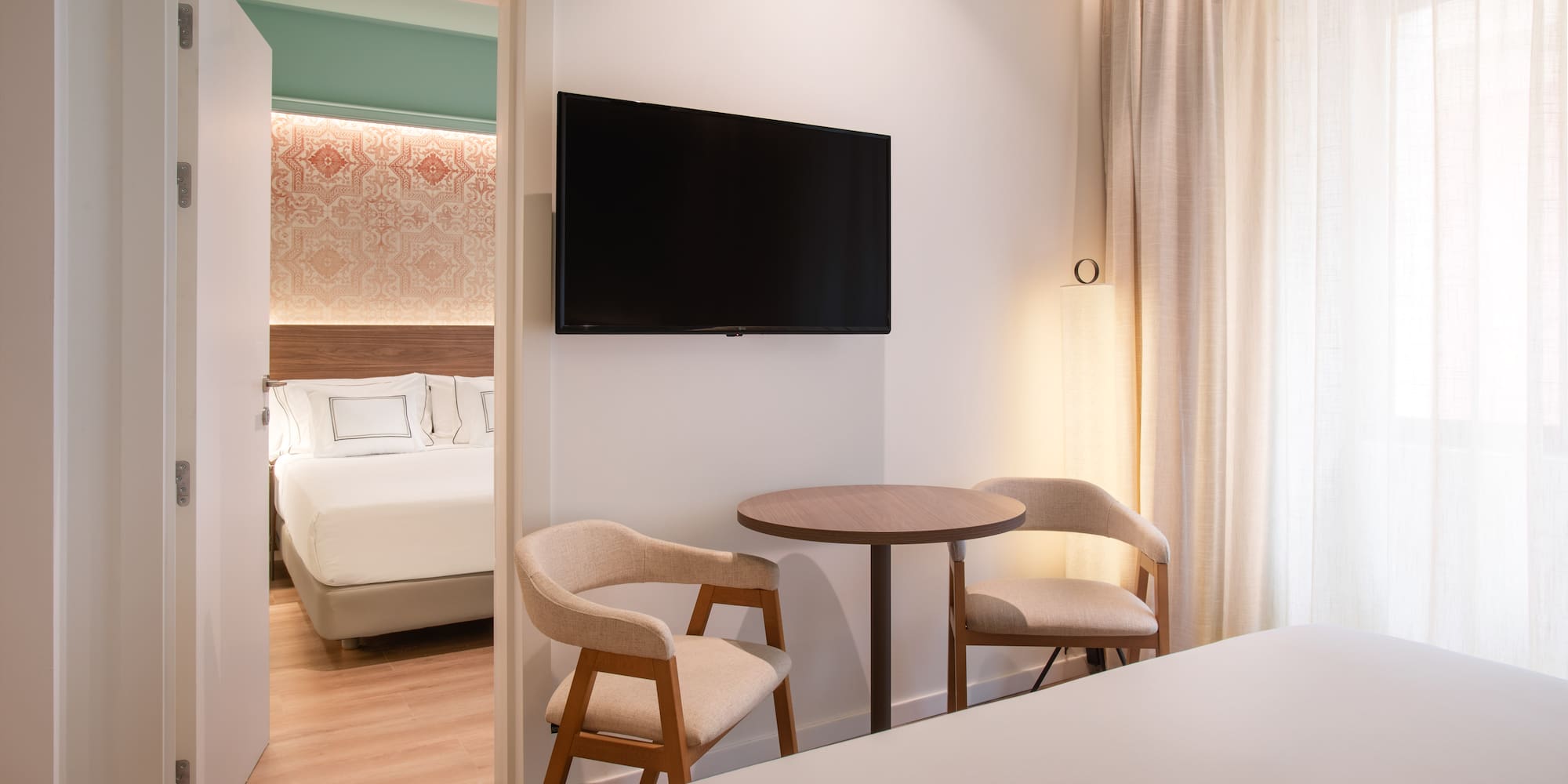 a room with a tv and a bed