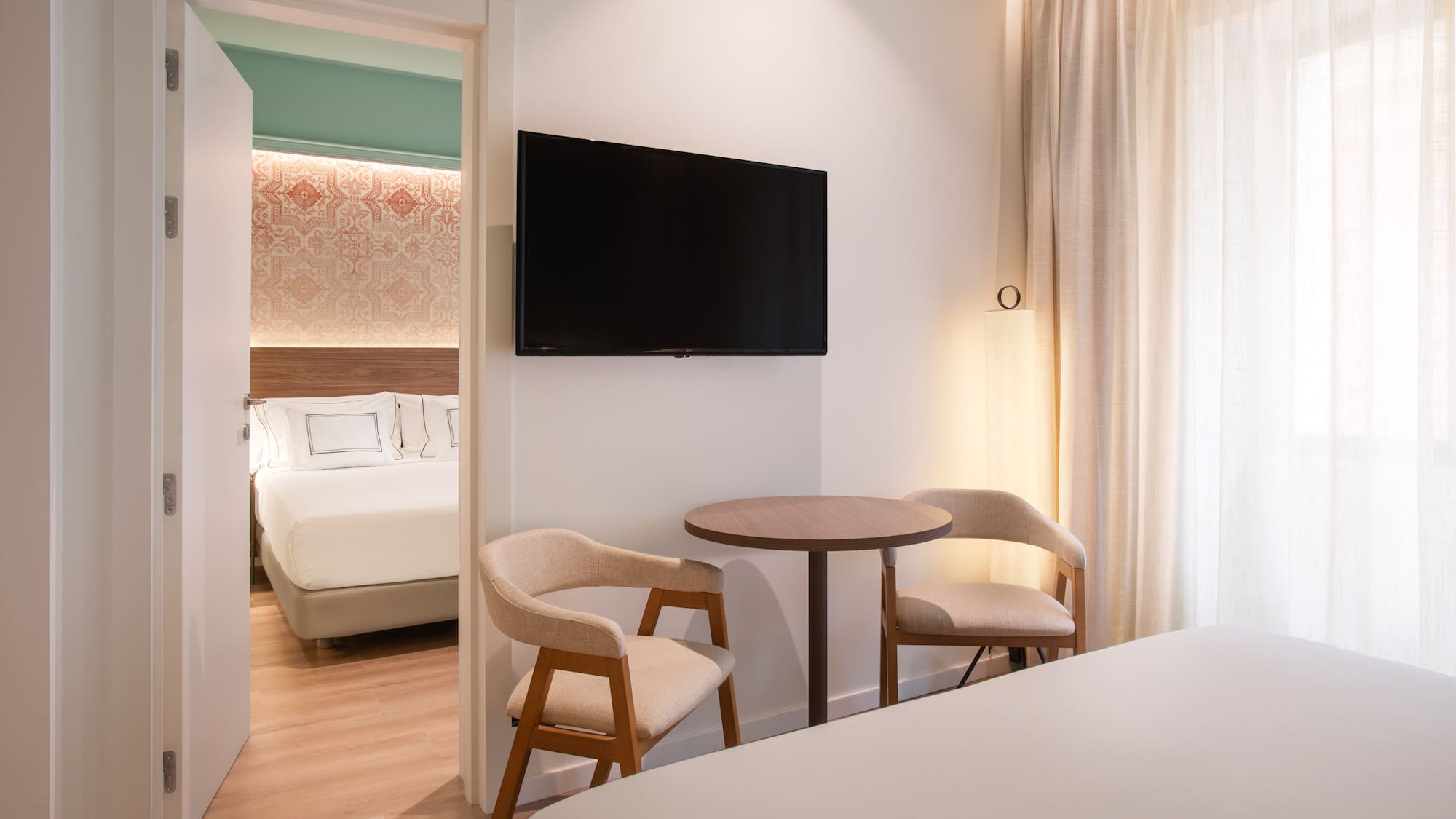 a room with a tv and a bed