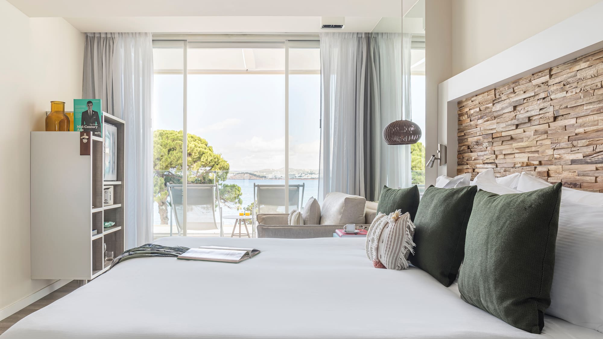 a bed with pillows and a book on it