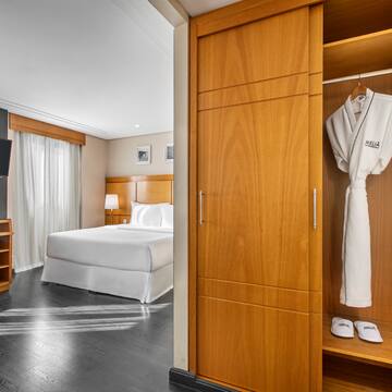 a room with a bed and a white robe