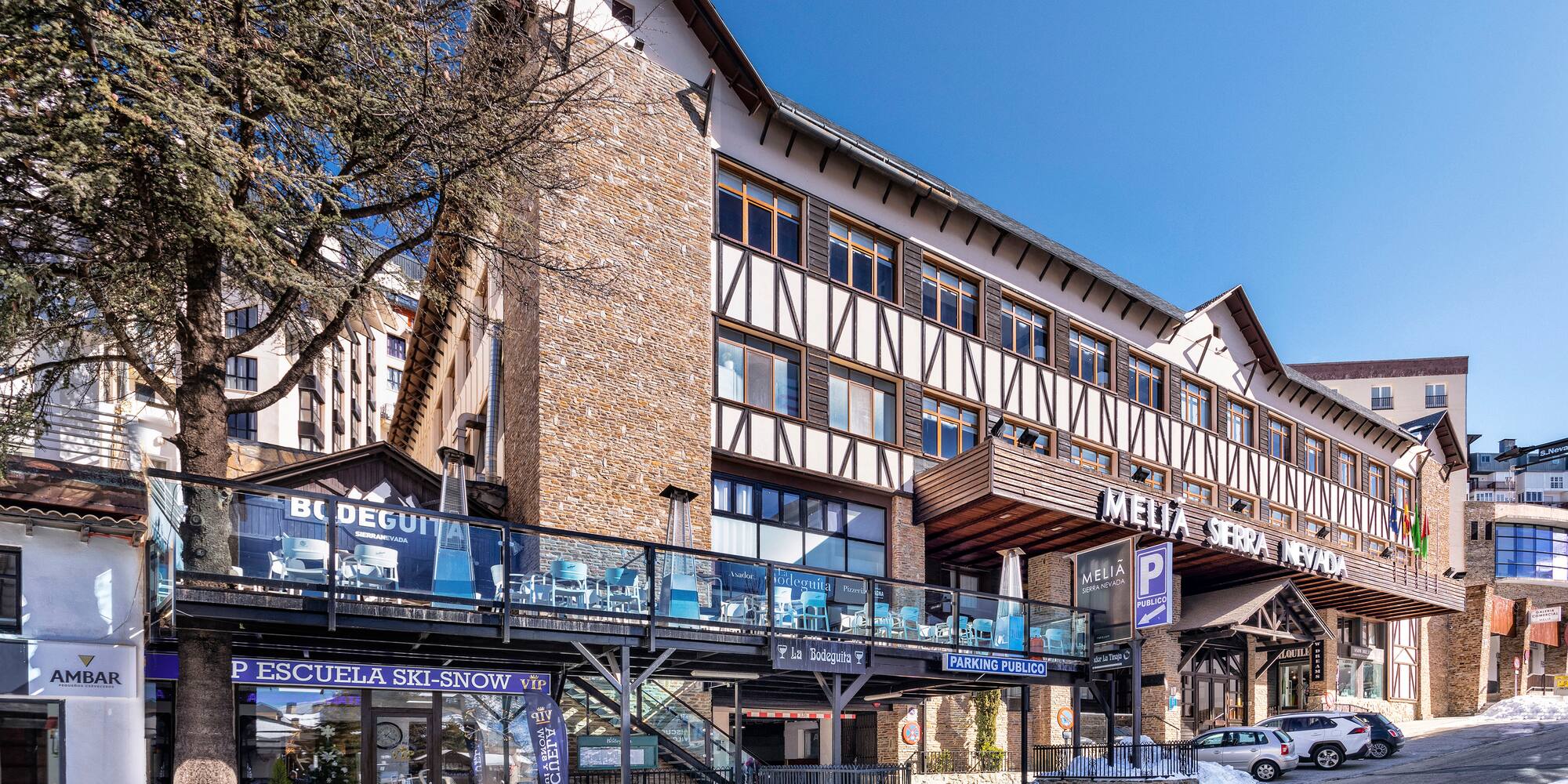 a building with a walkway and a sign on it