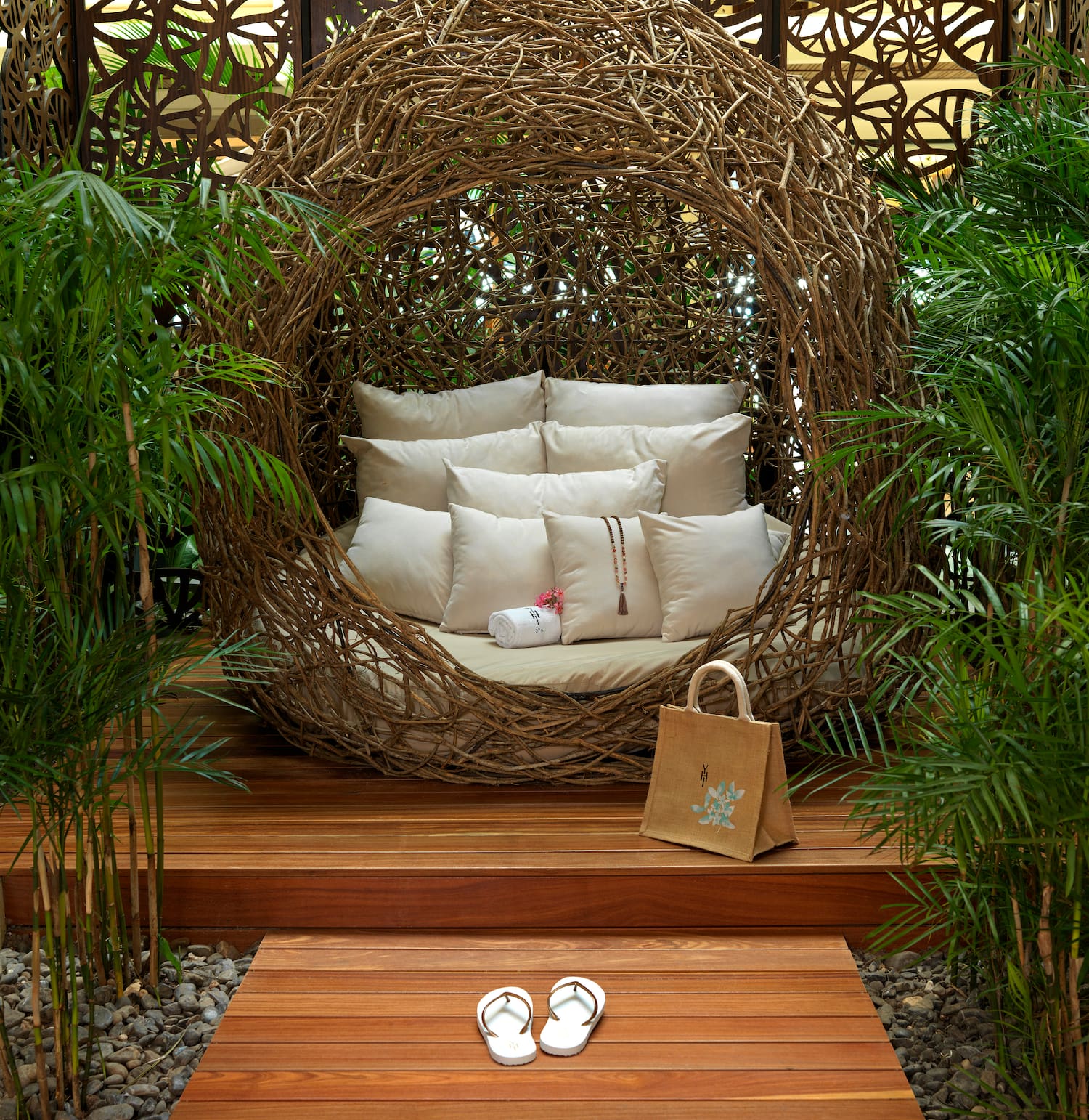 a chair with pillows and sandals in front of a wood deck