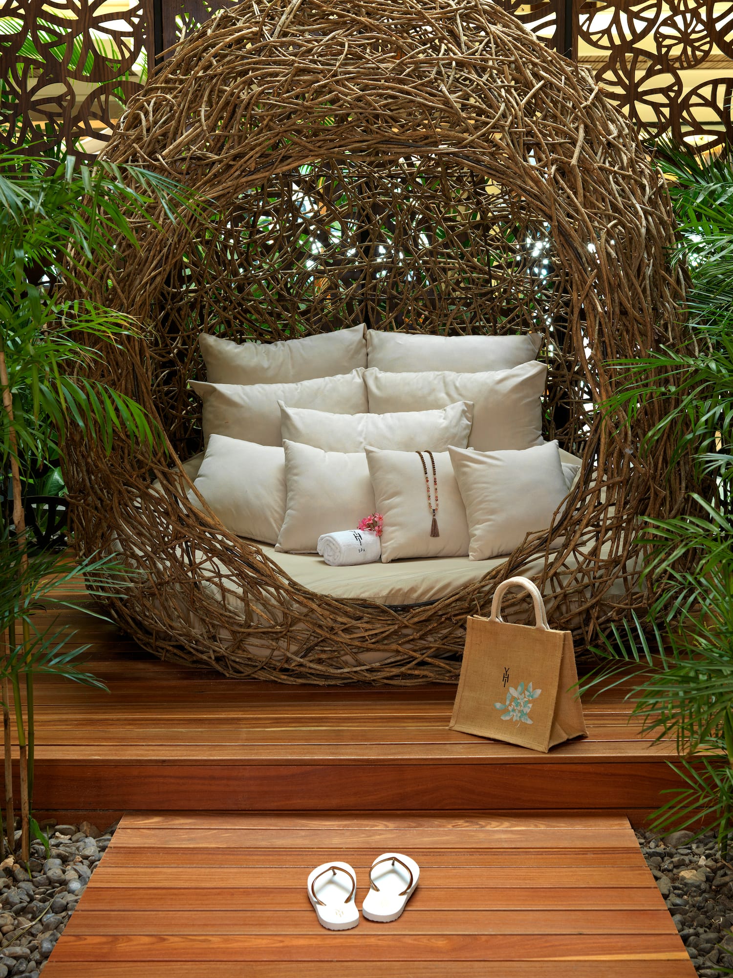 a chair with pillows and sandals in front of a wood deck