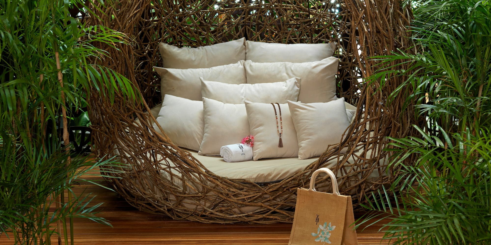 a chair with pillows and sandals in front of a wood deck