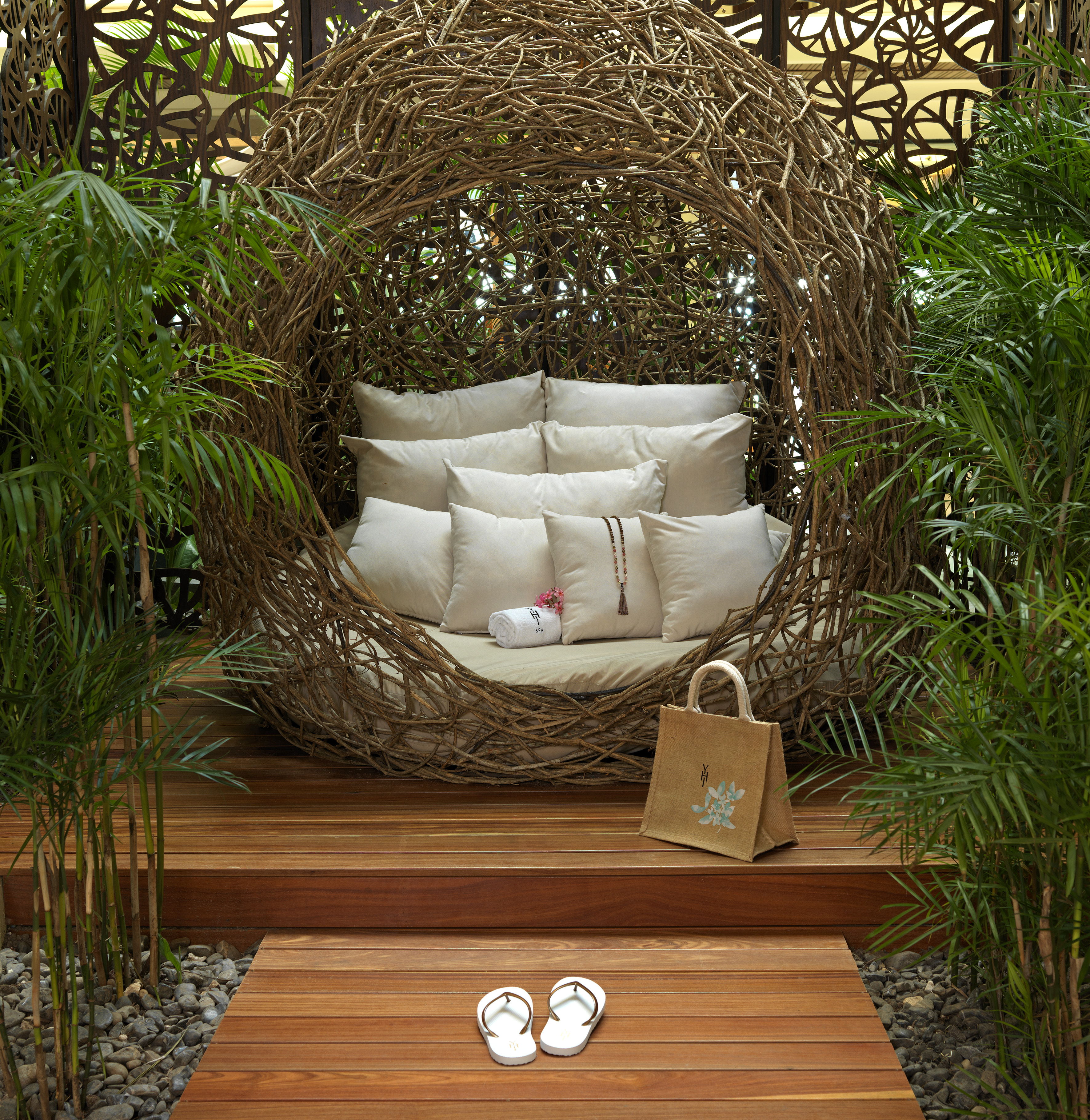 a chair with pillows and sandals in front of a wood deck
