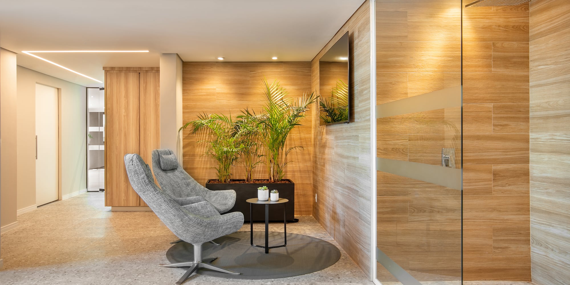 a room with a glass door and a chair