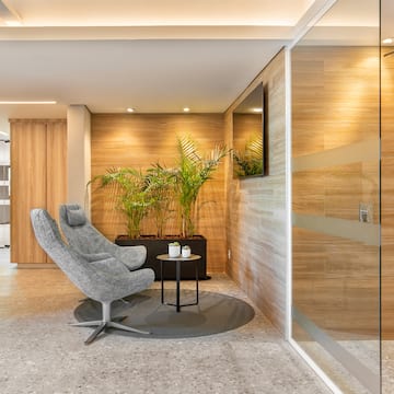 a room with a glass door and a chair