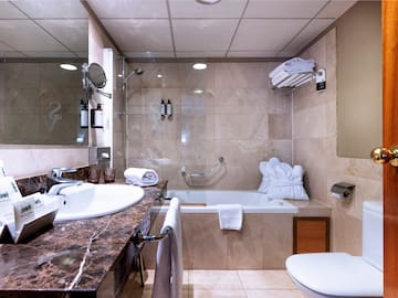 a bathroom with a sink toilet and tub